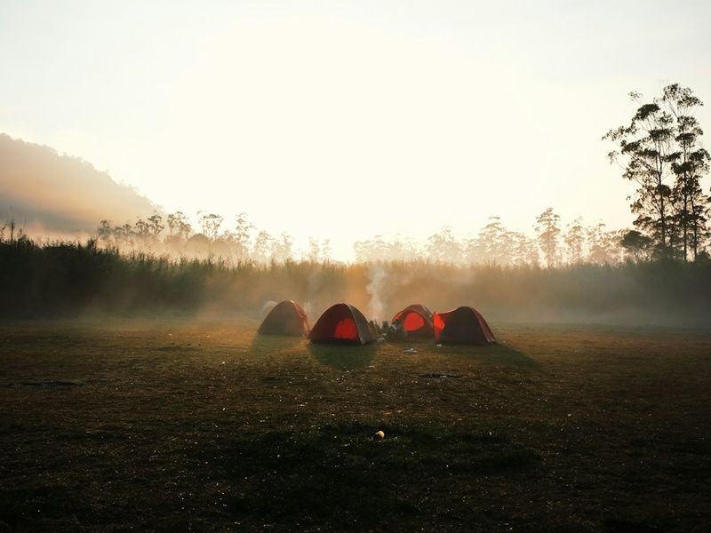Camping gear laid out by a tent